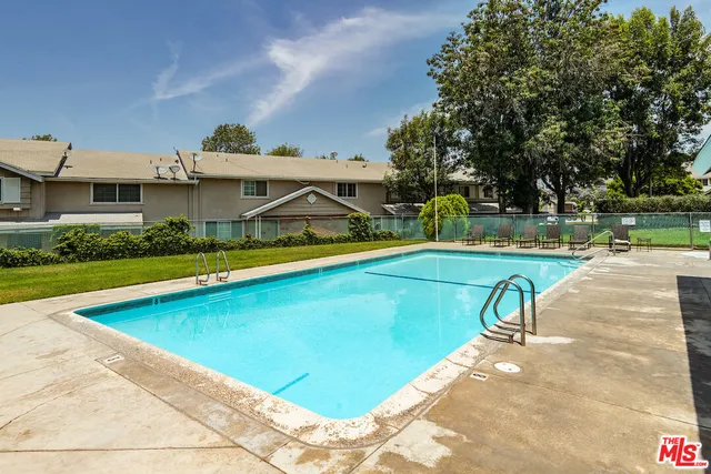 a view of a swimming pool with a lounge chairs