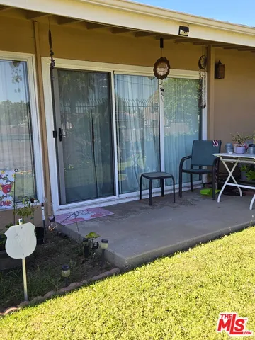 a backyard of a house with table and chairs