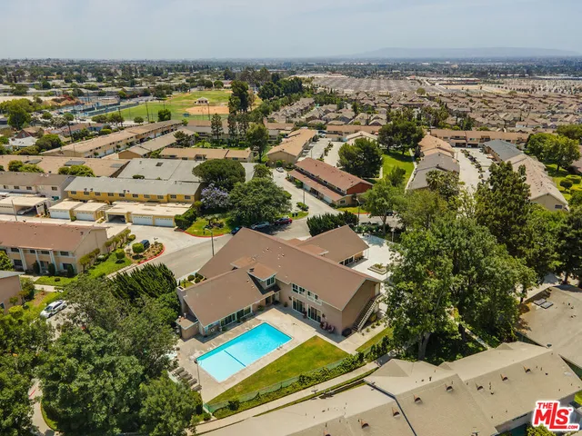 an aerial view of residential house with outdoor space and trees all around