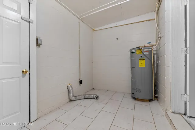 a view of backyard with wooden fence and trees