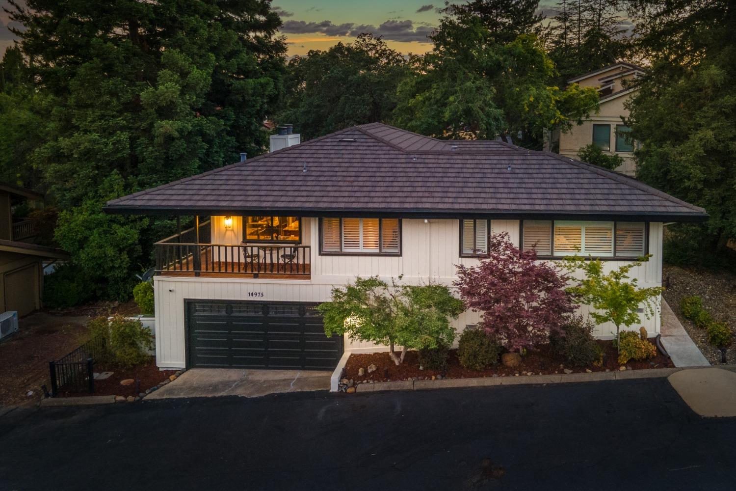 a front view of a house with a garden