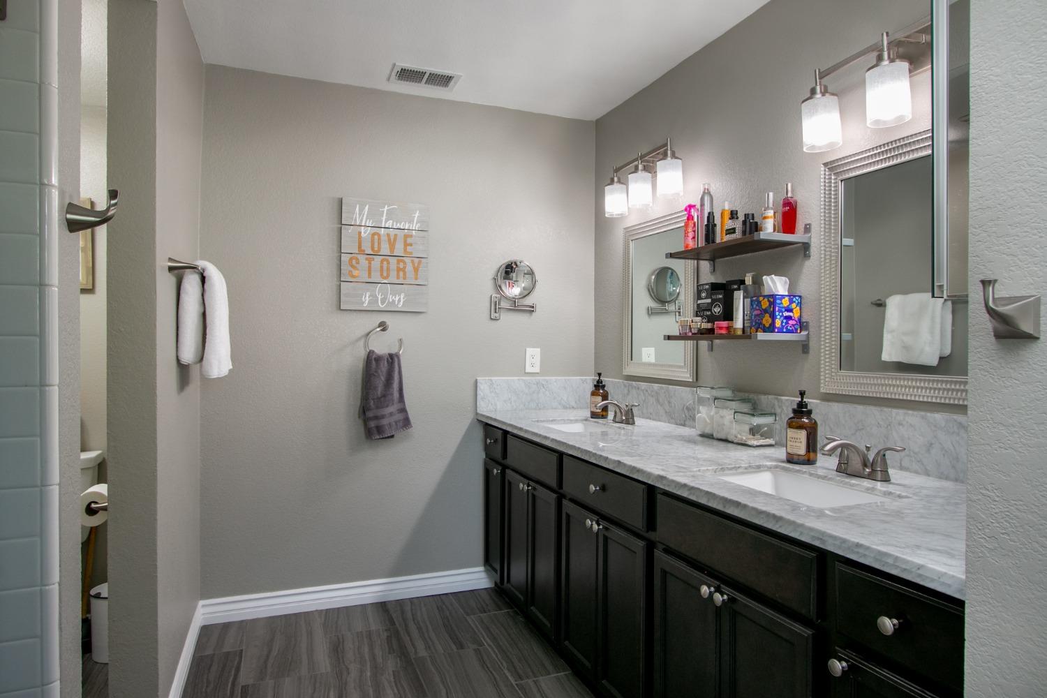 14975 Lago Drive Rancho Murieta, CA 95683 - Photo 14 of 41 a bathroom with a double vanity sink and a mirror