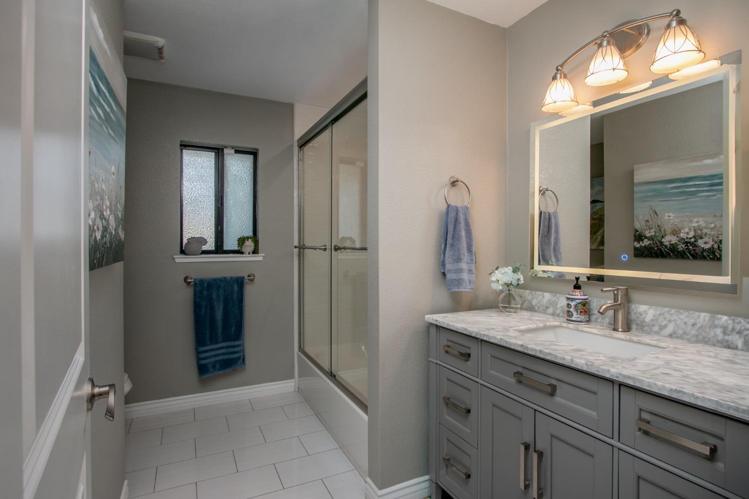 14975 Lago Drive Rancho Murieta, CA 95683 - Photo 18 of 41 a bathroom with a granite countertop sink and a mirror