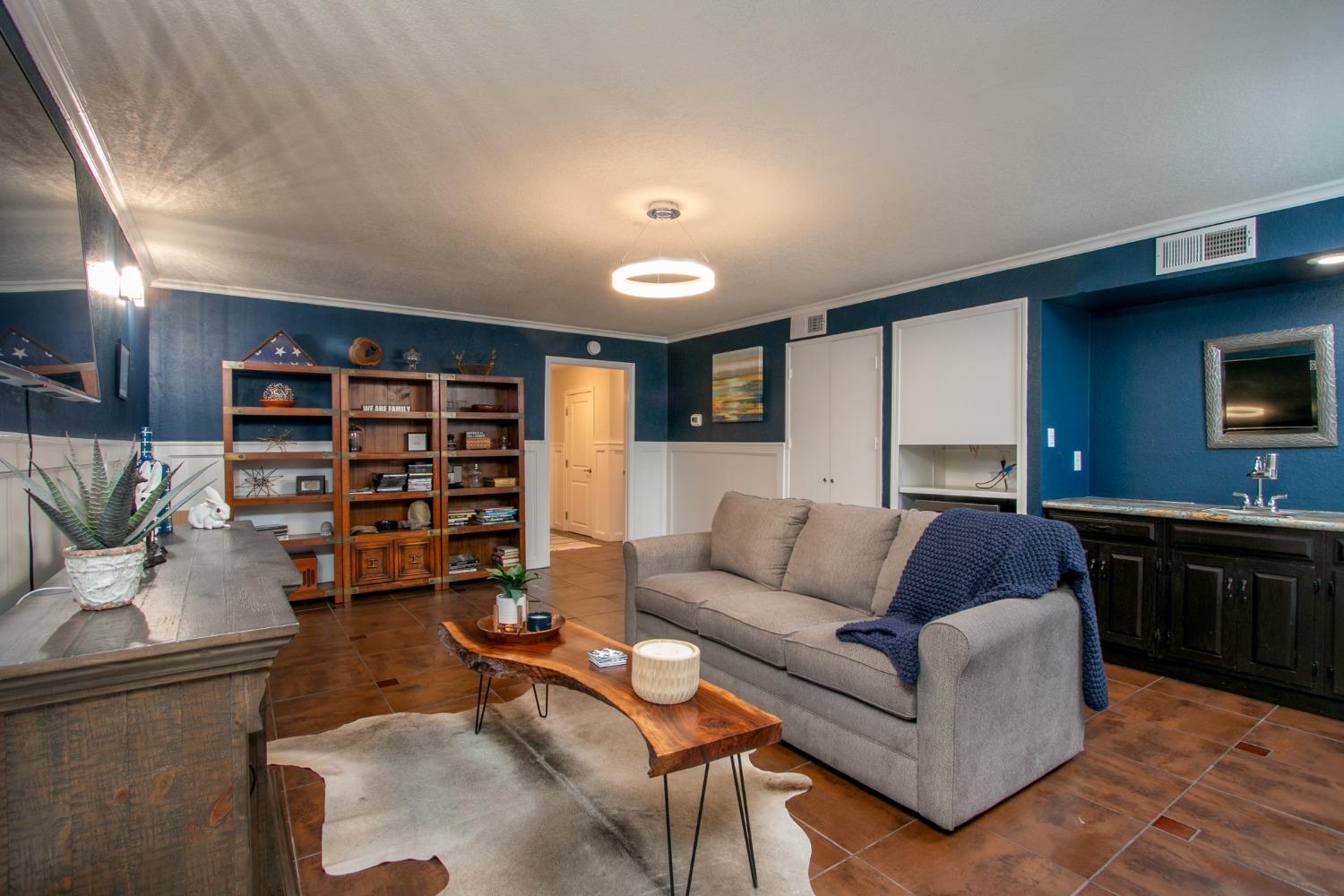14975 Lago Drive Rancho Murieta, CA 95683 - Photo 22 of 41 a living room with furniture and a flat screen tv