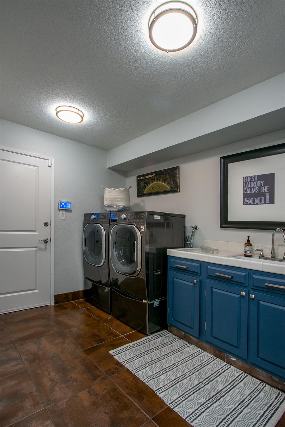 14975 Lago Drive Rancho Murieta, CA 95683 - Photo 26 of 41 a room with furniture a washer and dryer