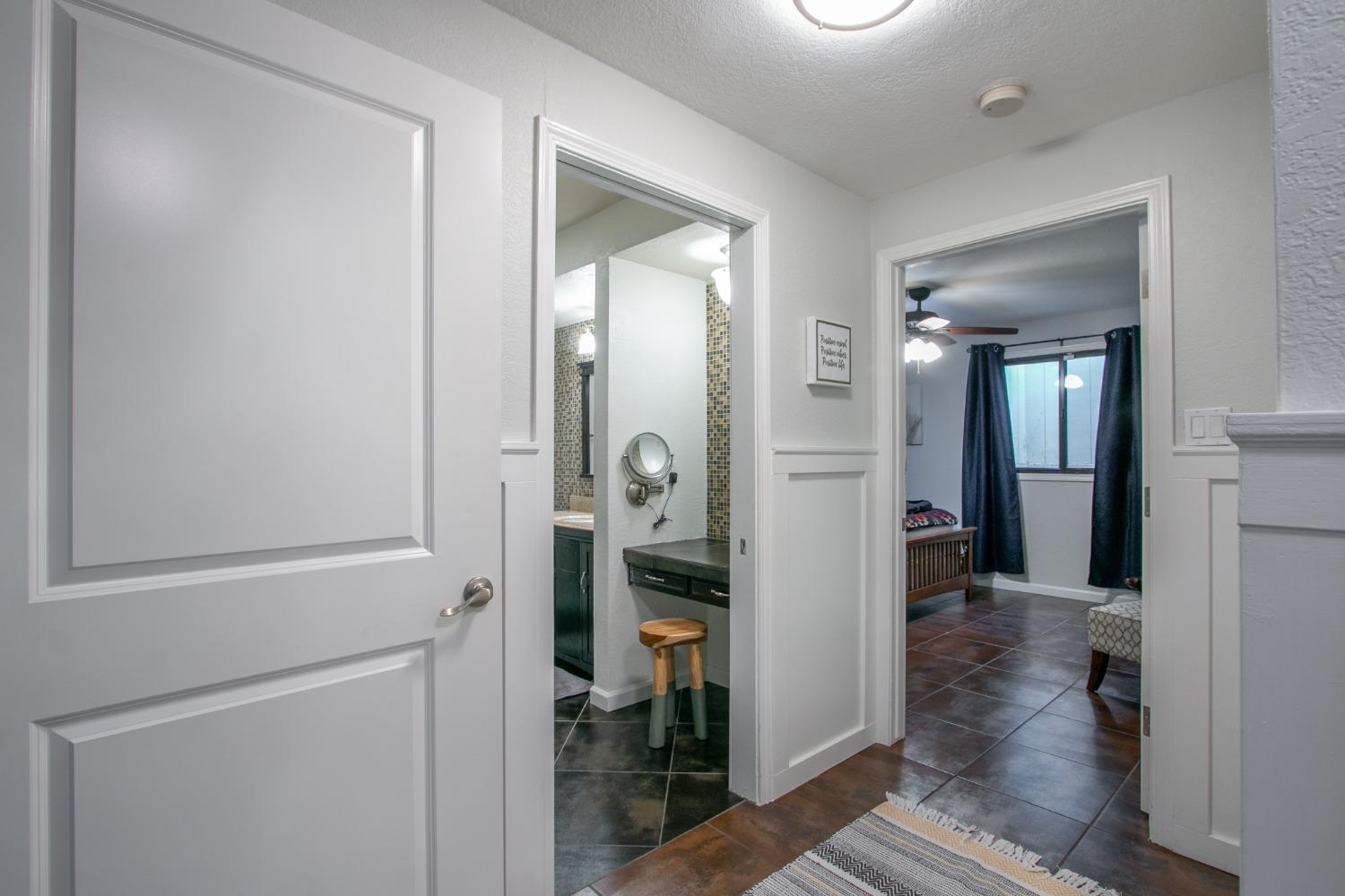 14975 Lago Drive Rancho Murieta, CA 95683 - Photo 28 of 41 a view of a hallway with wooden floor and a bathroom