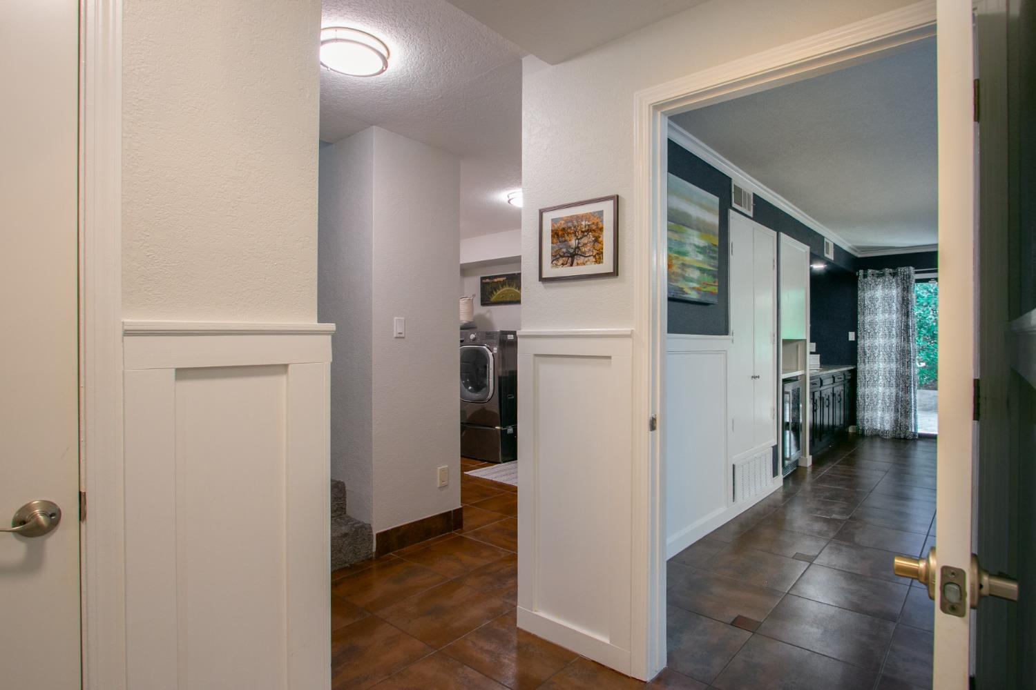 14975 Lago Drive Rancho Murieta, CA 95683 - Photo 29 of 41 a view of a hallway with bathroom and wooden floor