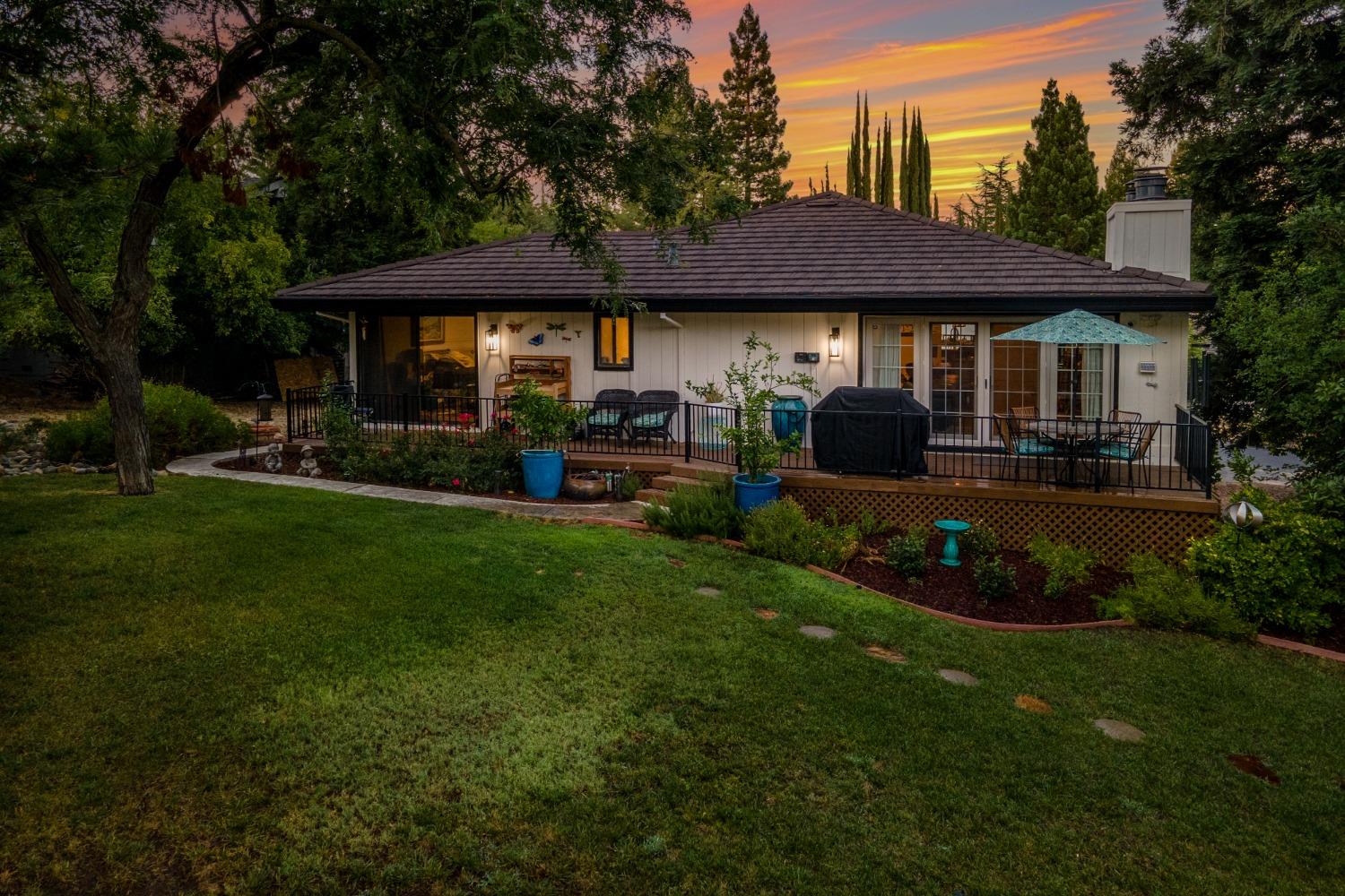 14975 Lago Drive Rancho Murieta, CA 95683 - Photo 34 of 41 a front view of a house with a garden and trees