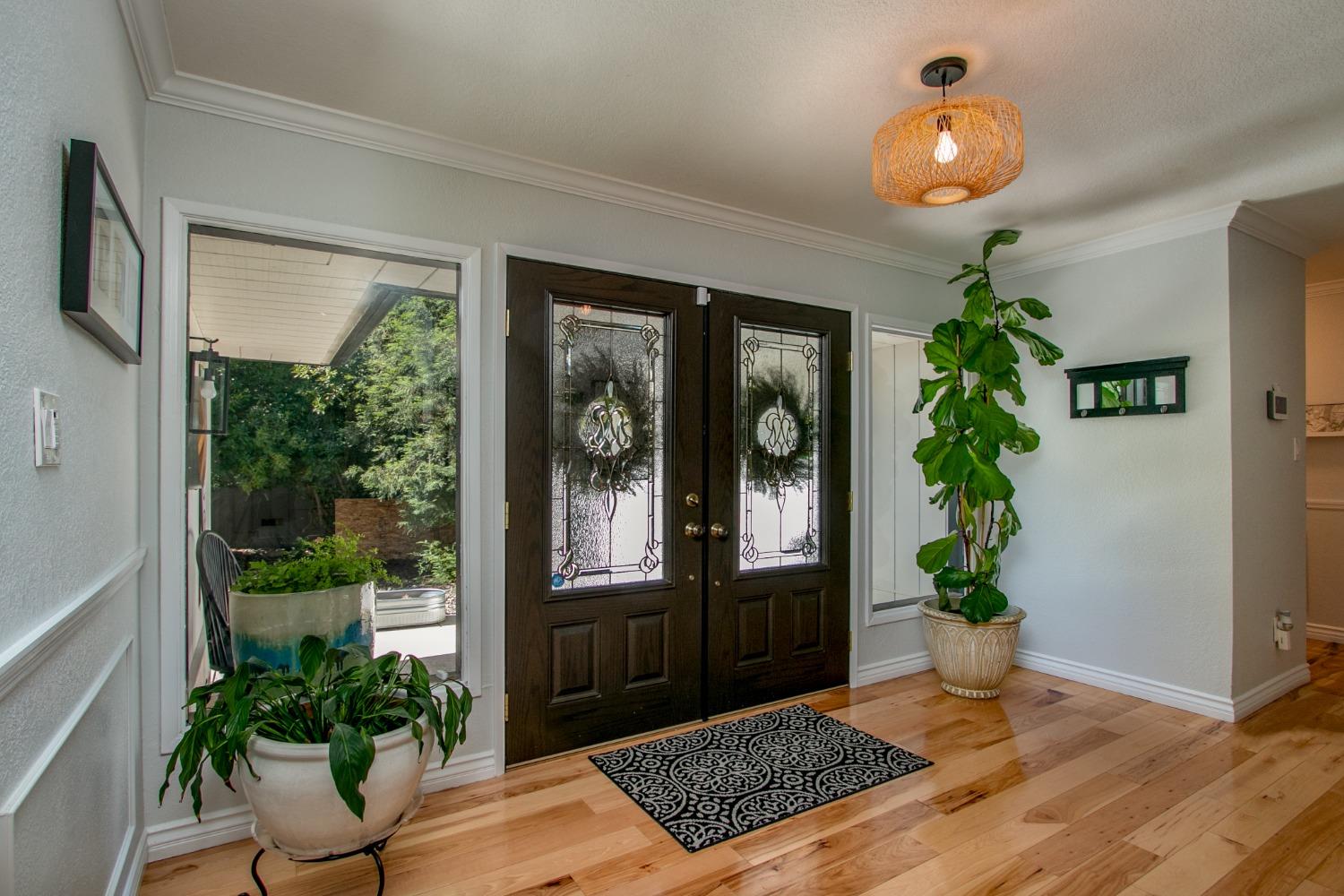 14975 Lago Drive Rancho Murieta, CA 95683 - Photo 4 of 41 a view of an entryway with wooden floor and a potted plant