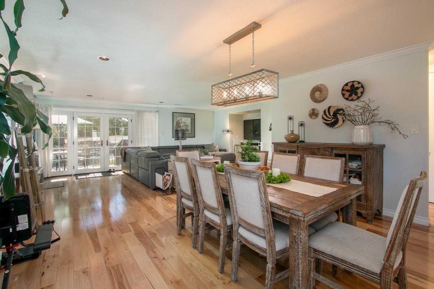 14975 Lago Drive Rancho Murieta, CA 95683 - Photo 8 of 41 a view of a dining room with furniture a chandelier and wooden floor