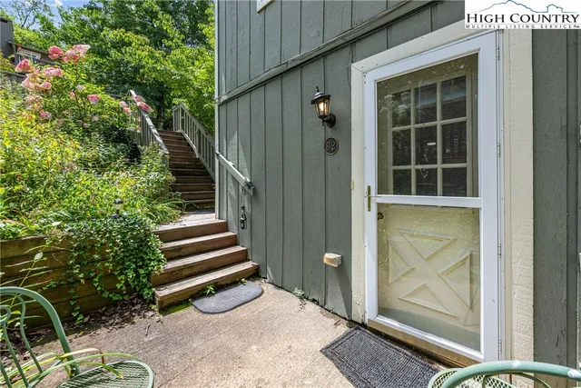 a view of a dining room with furniture and a chandelier