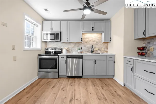 a large bedroom with a bed and wooden floor