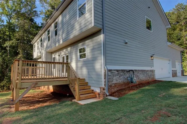 a view of a house with a yard and a deck
