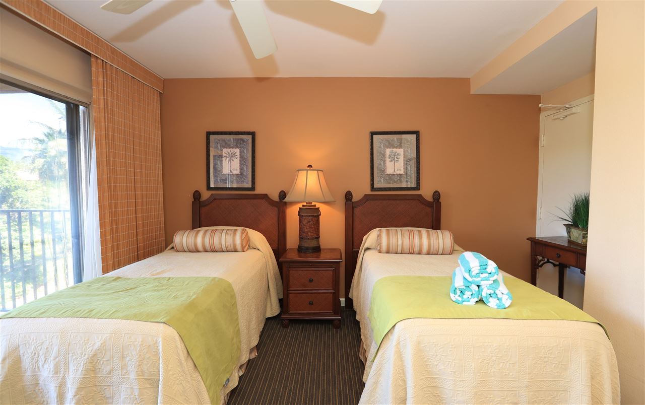 4401 Lower Honoapiilani Road, Unit B501 Lahaina, HI 96761 - Photo 14 of 14 a bedroom with two beds and a large window