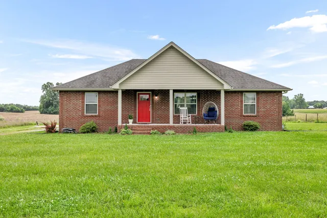 a view of a house with a backyard and porch