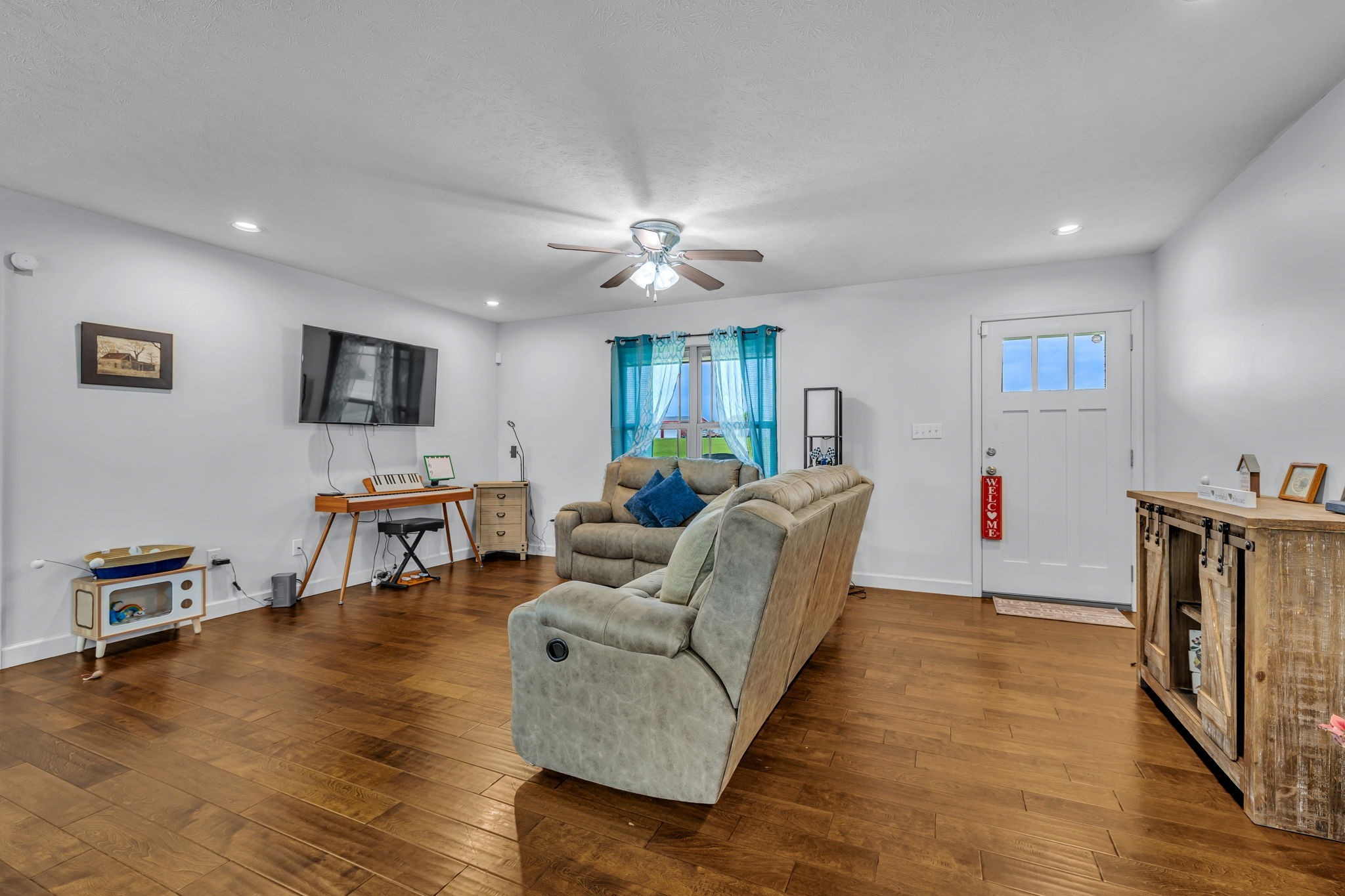 2164 Akersville Road Lafayette, TN 37083 - Photo 14 of 32 a living room with furniture and a flat screen tv