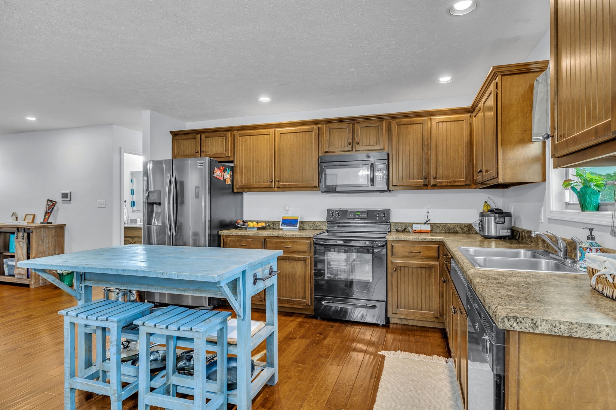 2164 Akersville Road Lafayette, TN 37083 - Photo 19 of 32 a kitchen with stainless steel appliances granite countertop a sink stove and refrigerator