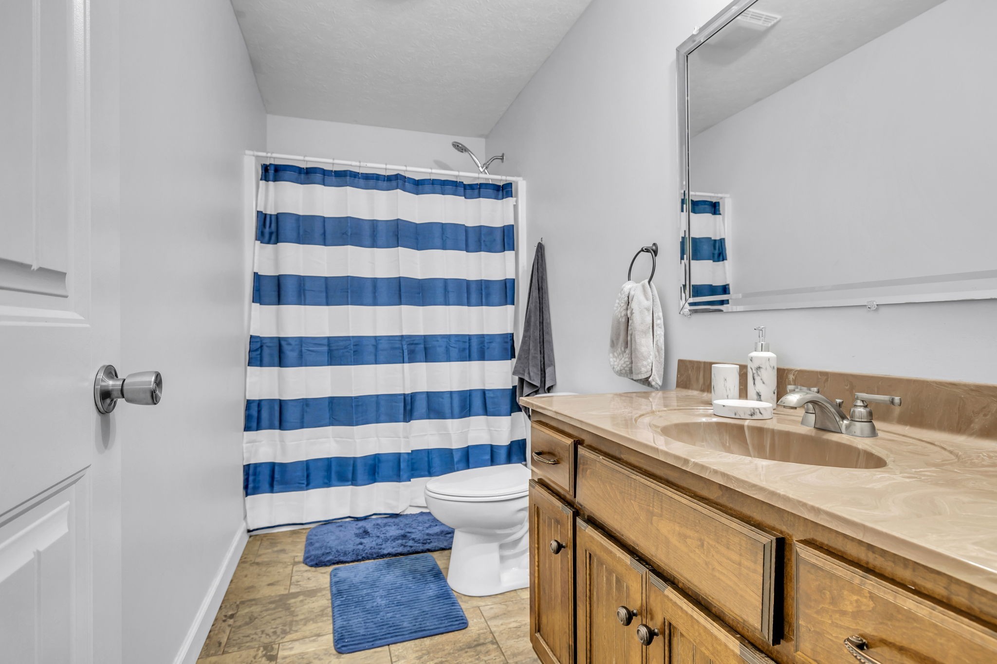 2164 Akersville Road Lafayette, TN 37083 - Photo 26 of 32 a bathroom with a sink a toilet a shower and a mirror