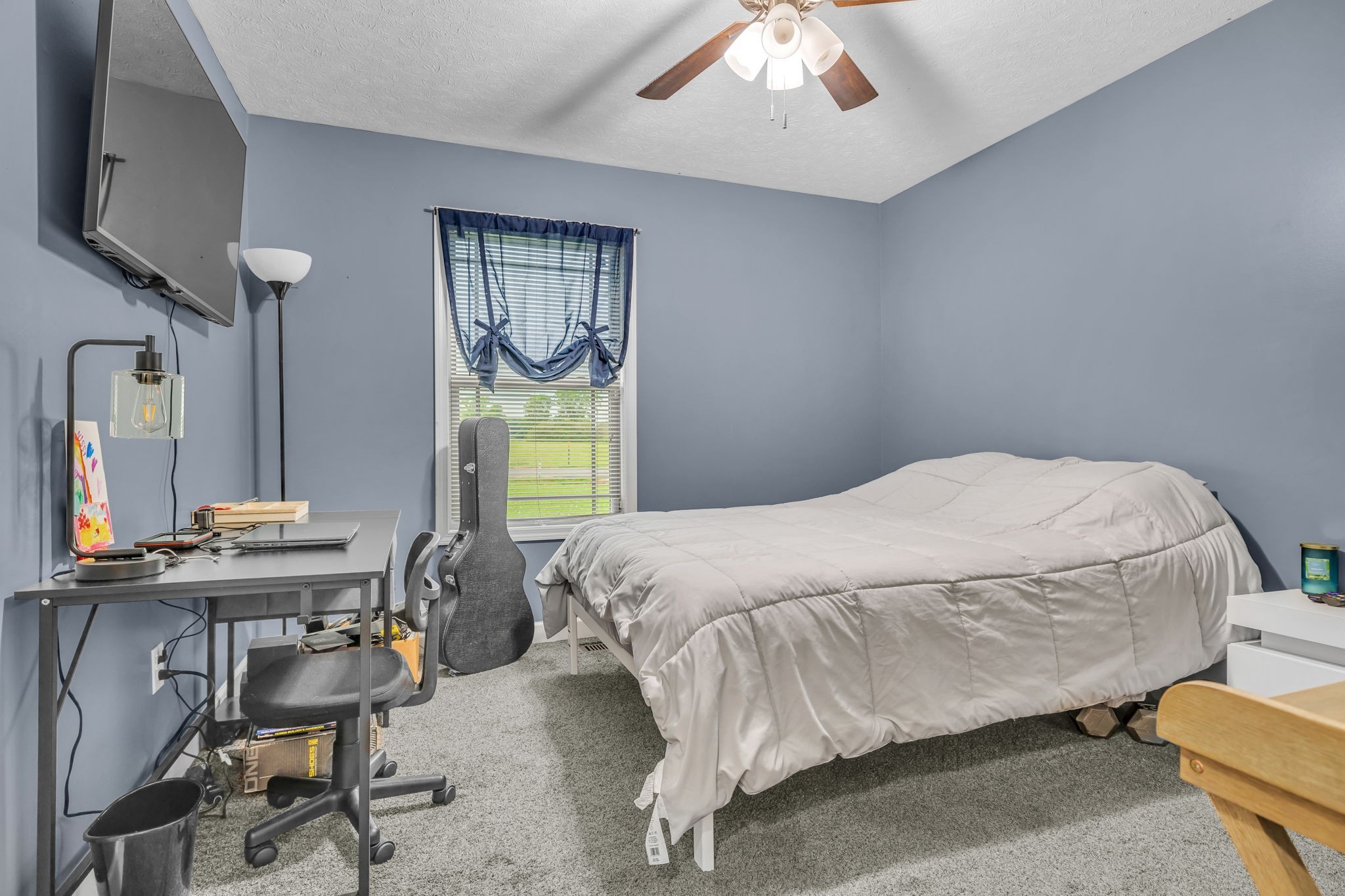 2164 Akersville Road Lafayette, TN 37083 - Photo 27 of 32 a bedroom with a bed a desk and chair