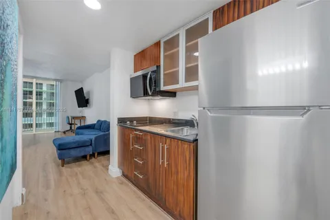 a bathroom with a sink a large mirror a toilet and bathtub