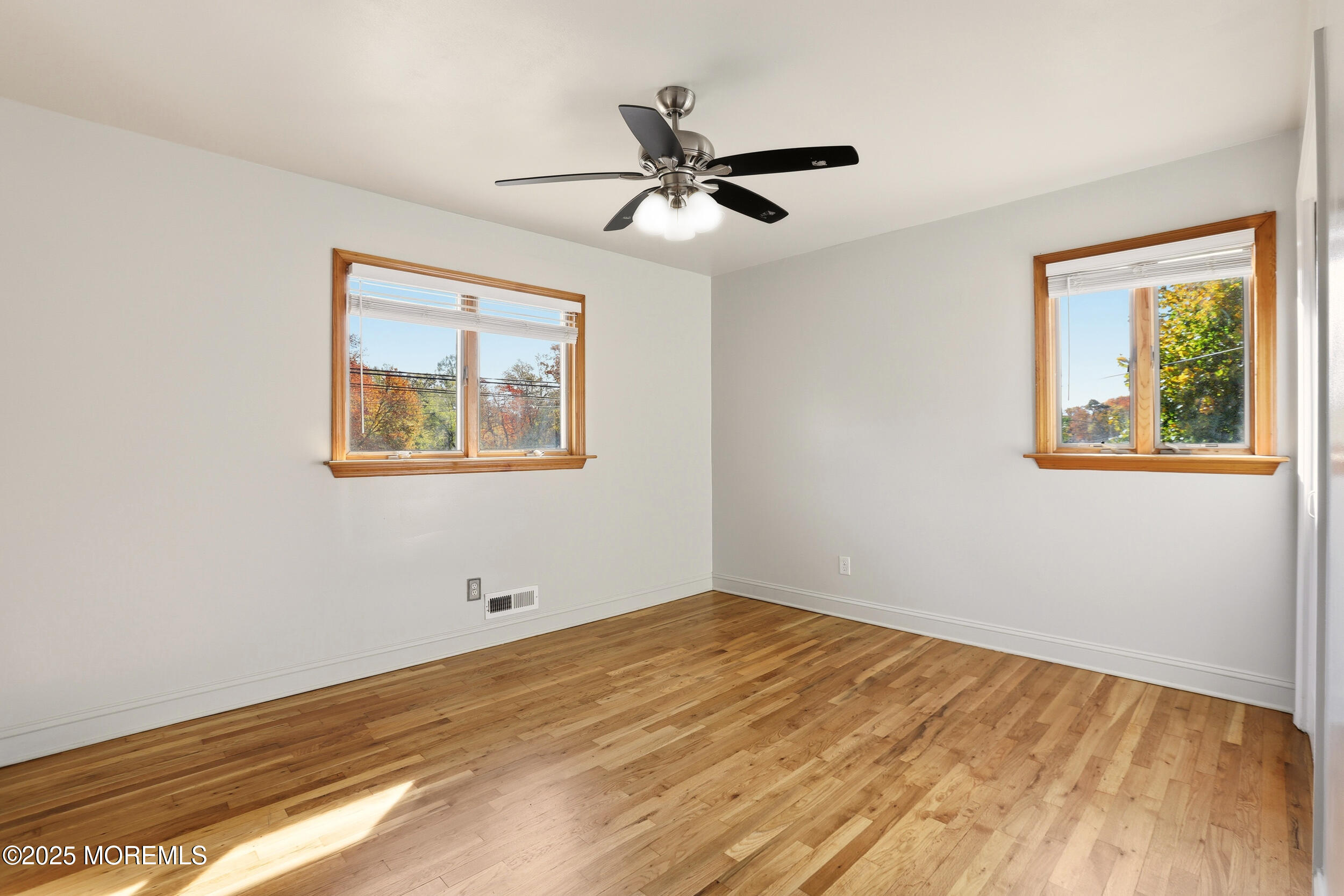 19 Kensington Drive Howell, NJ 07731 - Photo 19 of 31 a view of empty room with wooden floor and fan