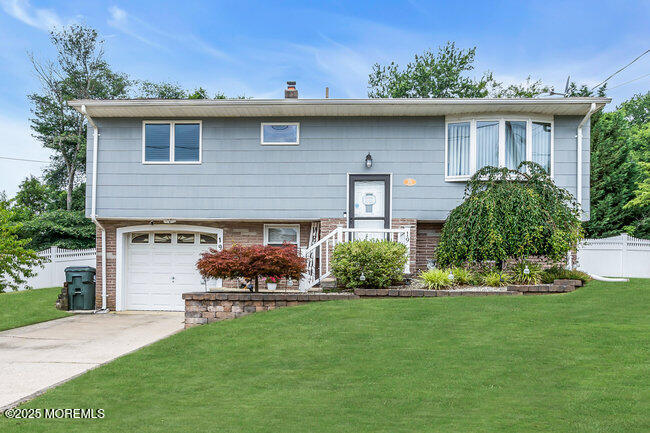 19 Kensington Drive Howell, NJ 07731 - Photo 2 of 31 a front view of a house with a garden