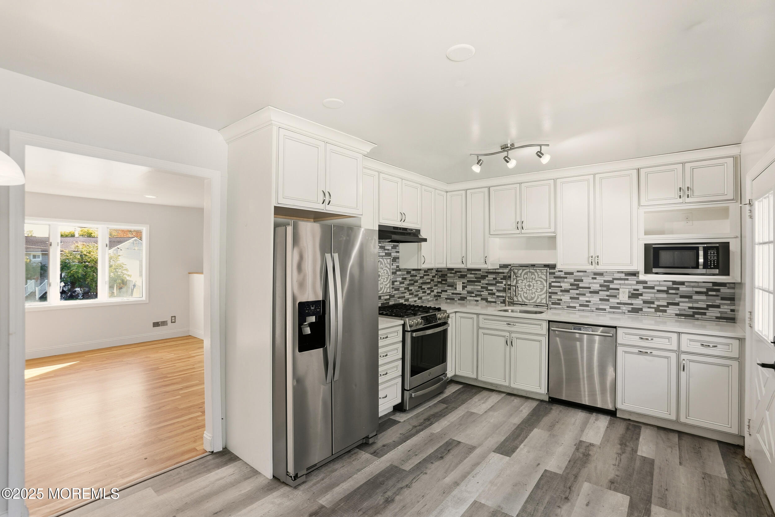 19 Kensington Drive Howell, NJ 07731 - Photo 23 of 31 a kitchen with stainless steel appliances granite countertop a refrigerator and a stove top oven