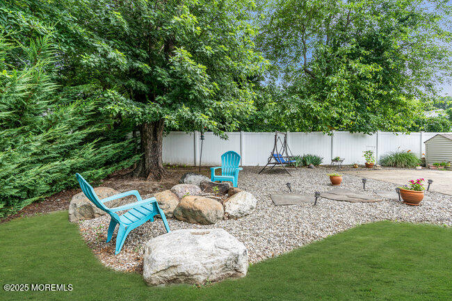 19 Kensington Drive Howell, NJ 07731 - Photo 4 of 31 a backyard of a house with table and chairs