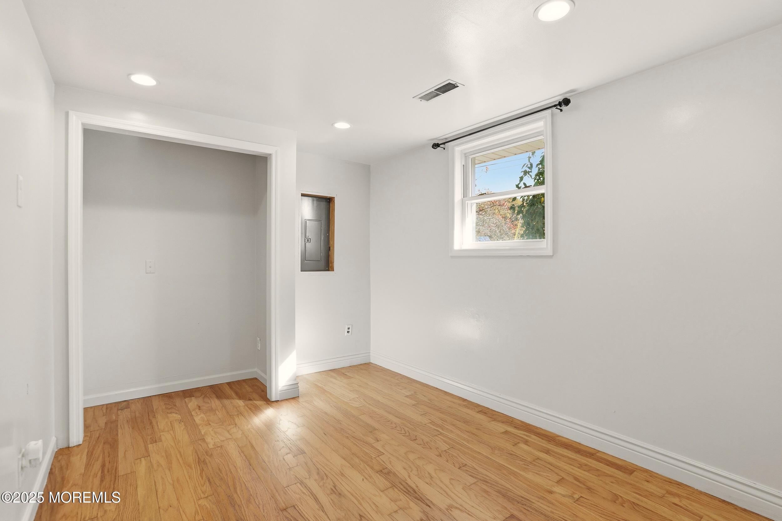 19 Kensington Drive Howell, NJ 07731 - Photo 9 of 31 a view of an empty room with wooden floor and a window