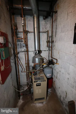 a room with water heater and utility racks