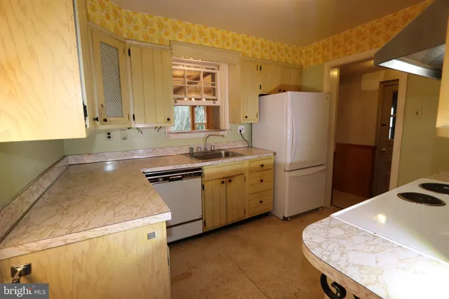a kitchen with a sink a stove and refrigerator