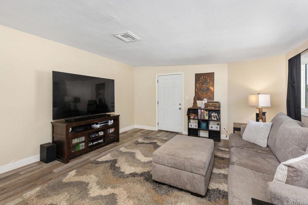 8229 Medill Avenue El Cajon, CA 92021 - Photo 11 of 34 a living room with furniture and a flat screen tv