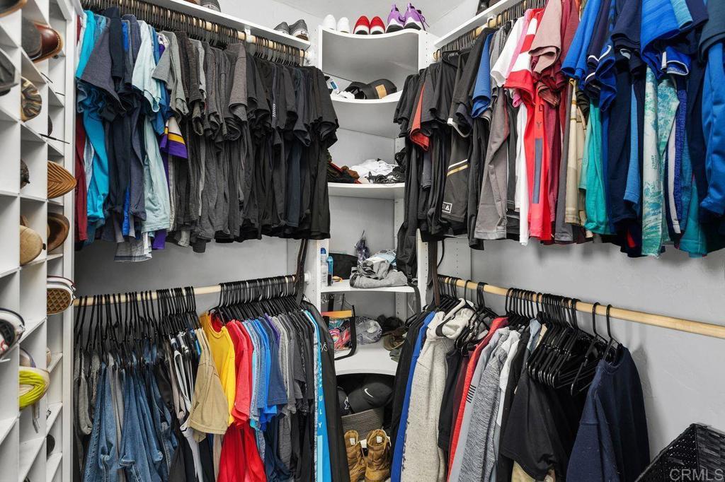 8229 Medill Avenue El Cajon, CA 92021 - Photo 18 of 34 a view of walk in closet with clothes and shoes
