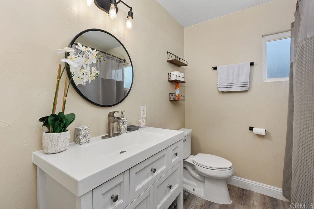 8229 Medill Avenue El Cajon, CA 92021 - Photo 23 of 34 a bathroom with a toilet a sink and a mirror