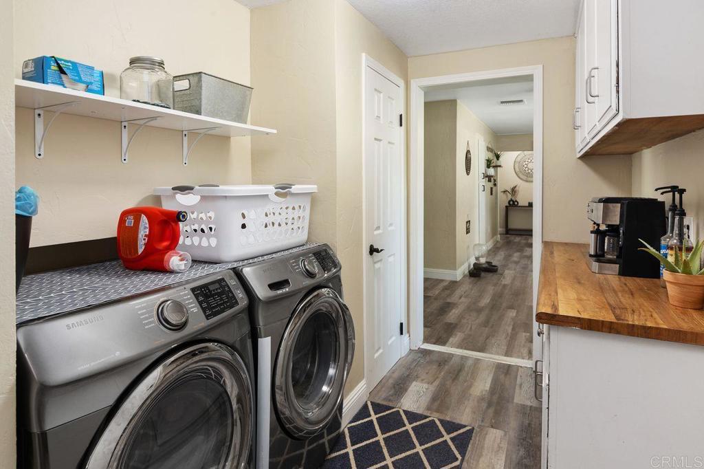 8229 Medill Avenue El Cajon, CA 92021 - Photo 25 of 34 a view of washer and dryer with kitchen in the background