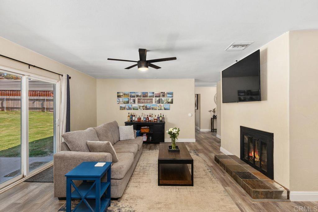 8229 Medill Avenue El Cajon, CA 92021 - Photo 8 of 34 a living room with furniture a flat screen tv and a fireplace