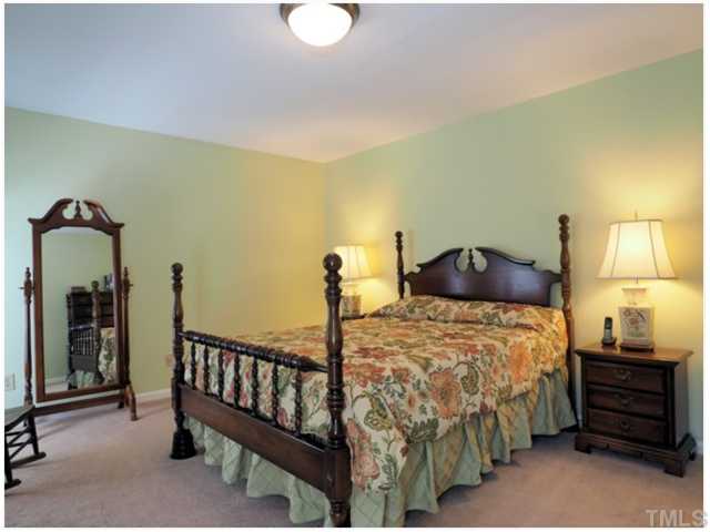 6208 Dresden Lane Raleigh, NC 27612 - Photo 14 of 25 a bedroom with a bed and a lamp