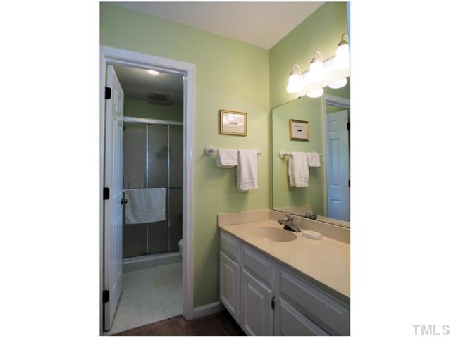 6208 Dresden Lane Raleigh, NC 27612 - Photo 15 of 25 a bathroom with a sink and a mirror