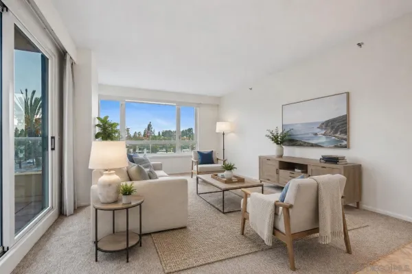 a living room with furniture fireplace and a large window