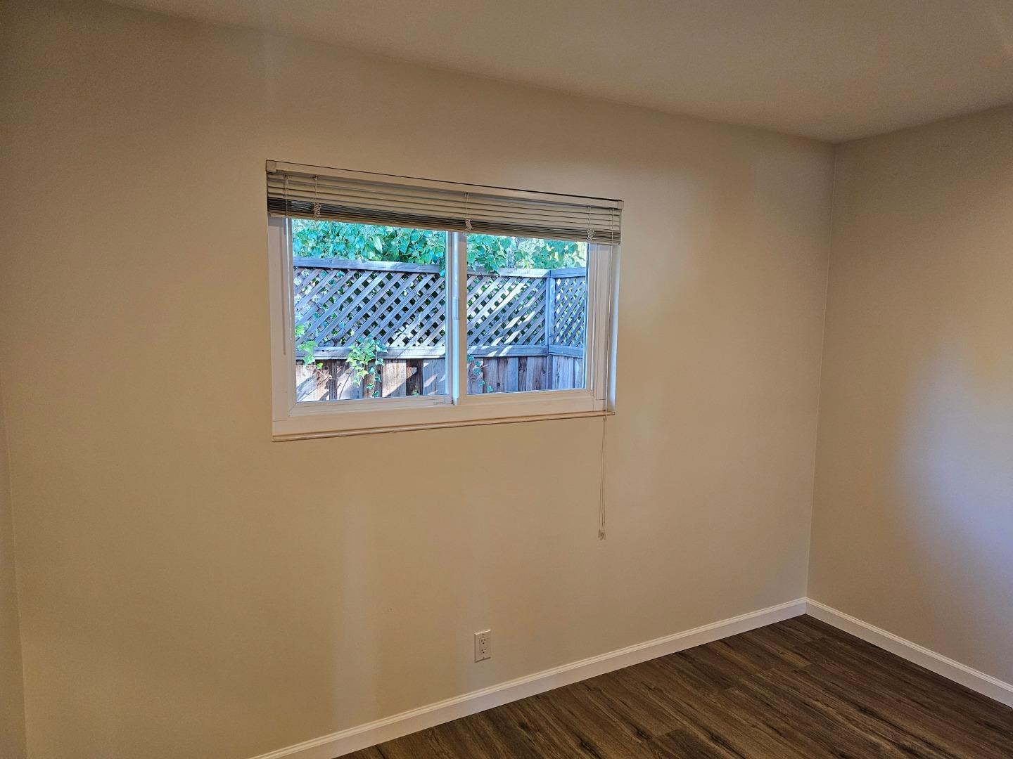 282 Monroe Drive, Unit 1 Mountain View, CA 94040 - Photo 9 of 14 a view of small space with wooden floor and a window