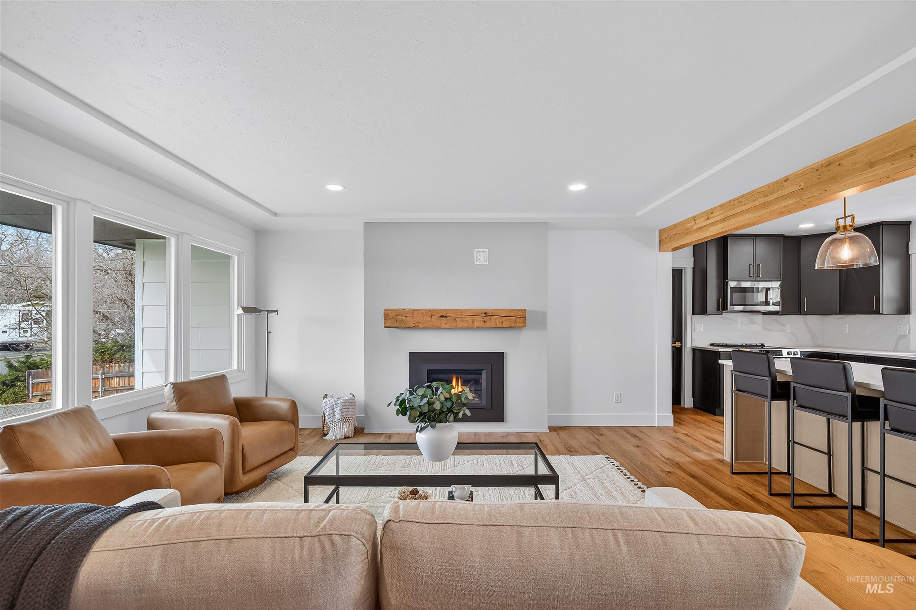 3513 8th Street Lewiston, ID 83501 - Photo 22 of 41 Living area with light wood-style floors, recessed lighting, and a warm lit fireplace