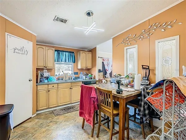 a view of a dining room with furniture and a kitchen
