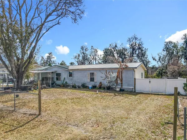 a view of a house with a yard covered in snow