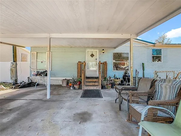a view of a patio with table and chairs and potted plants