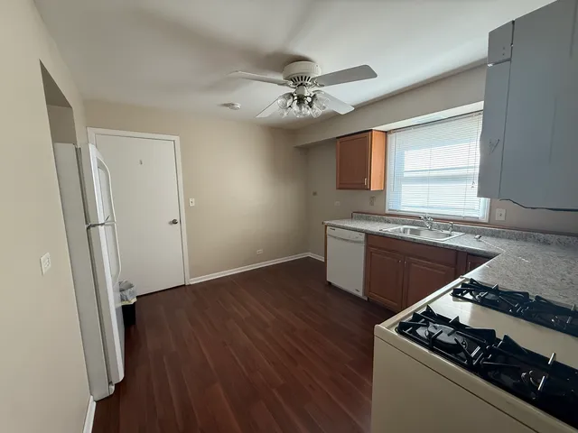 a kitchen with granite countertop a stove and a refrigerator