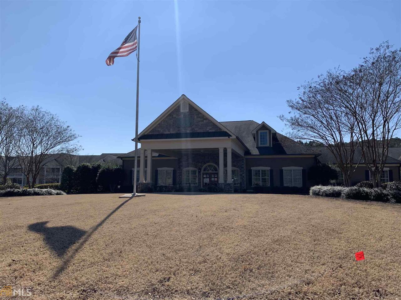 a front view of a house with a yard covered in snow