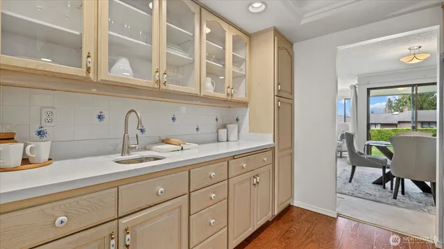 a kitchen with cabinets and wooden floor