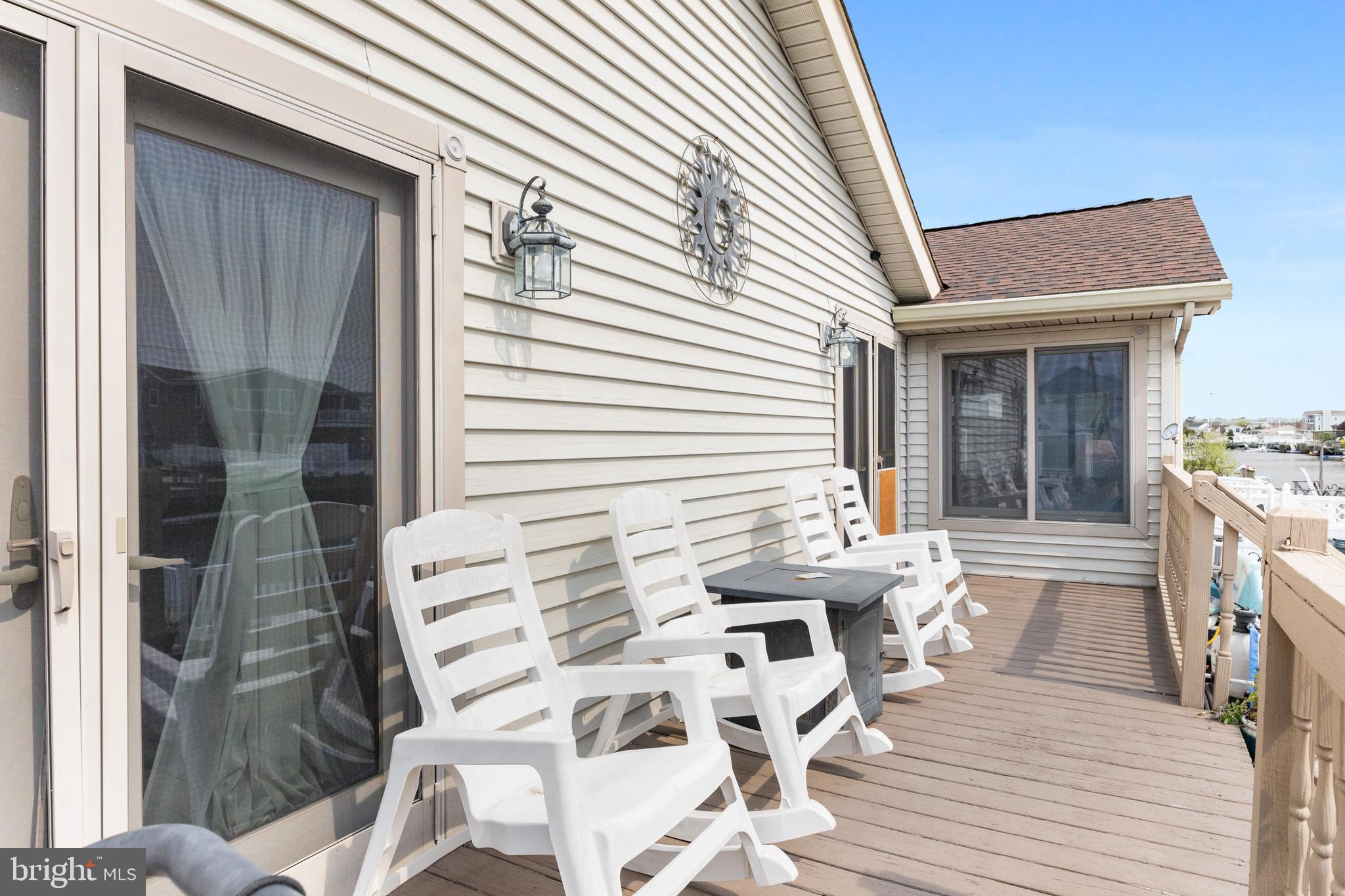 8 South Captain Drive Tuckerton, NJ 08087 - Photo 27 of 52 a view of a patio with couches and table and chairs with wooden floor and fence