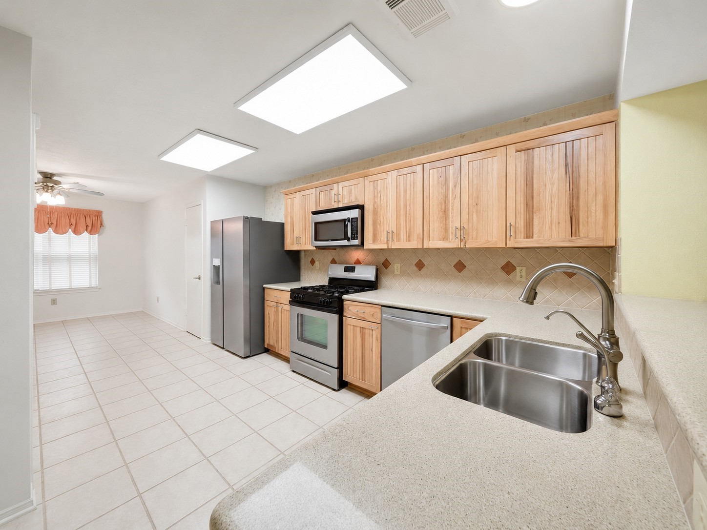 5010 Cupids Bower Court Spring, TX 77388 - Photo 10 of 40 Stainless steel appliances including gas range, handy microwave, new dishwasher, and new refrigerator. (Photo editing of this photo courtesy of AI.)