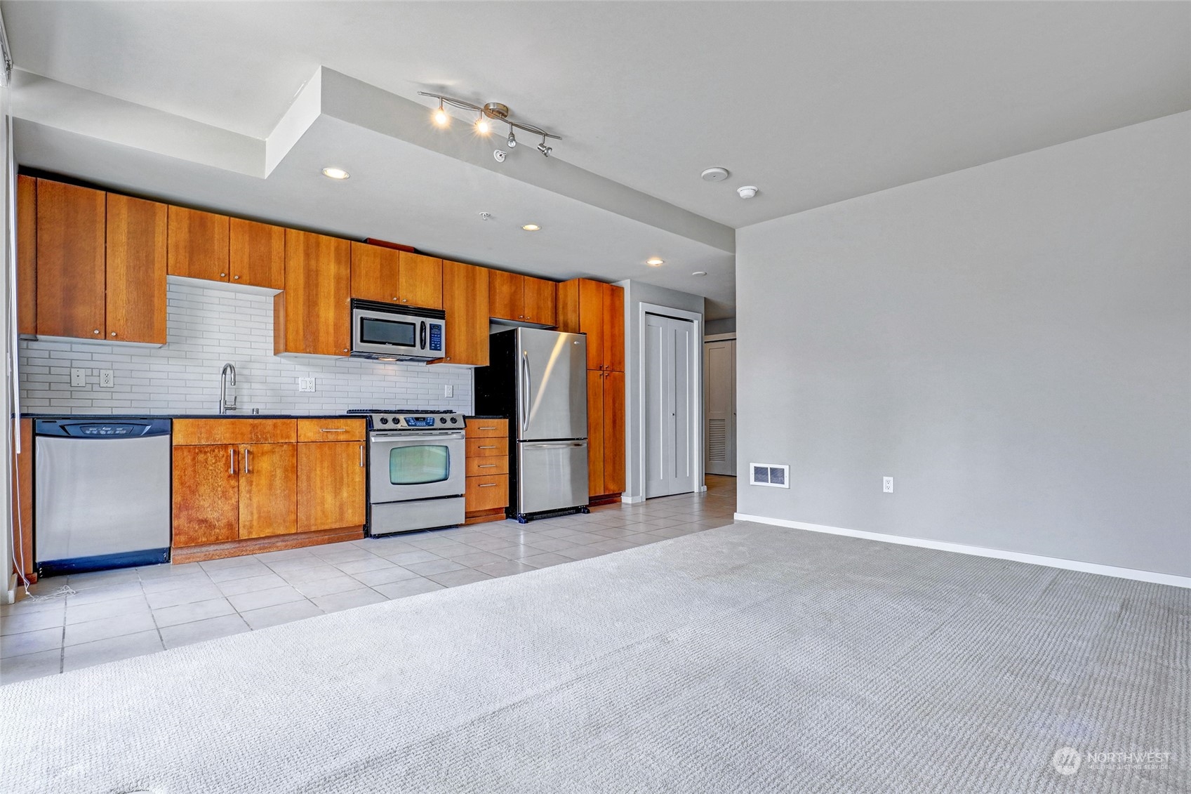 76 Cedar Street, Unit 710 Seattle, WA 98121 - Photo 4 of 20 a view of kitchen with stainless steel appliances granite countertop a refrigerator and a stove top oven